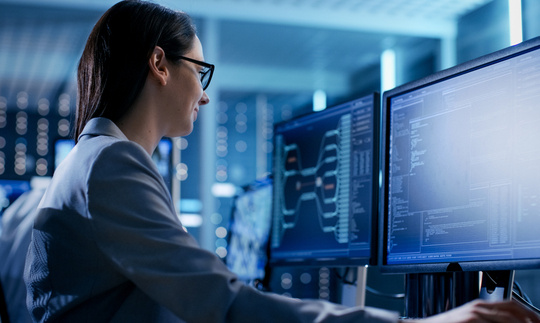 An IT professional working at a computer. An IT professional working at a computer.